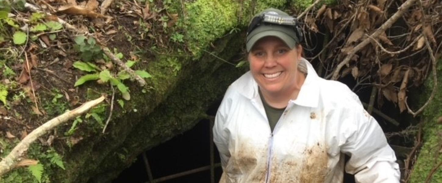 Tiffany Vickery spelunking in a a cave.