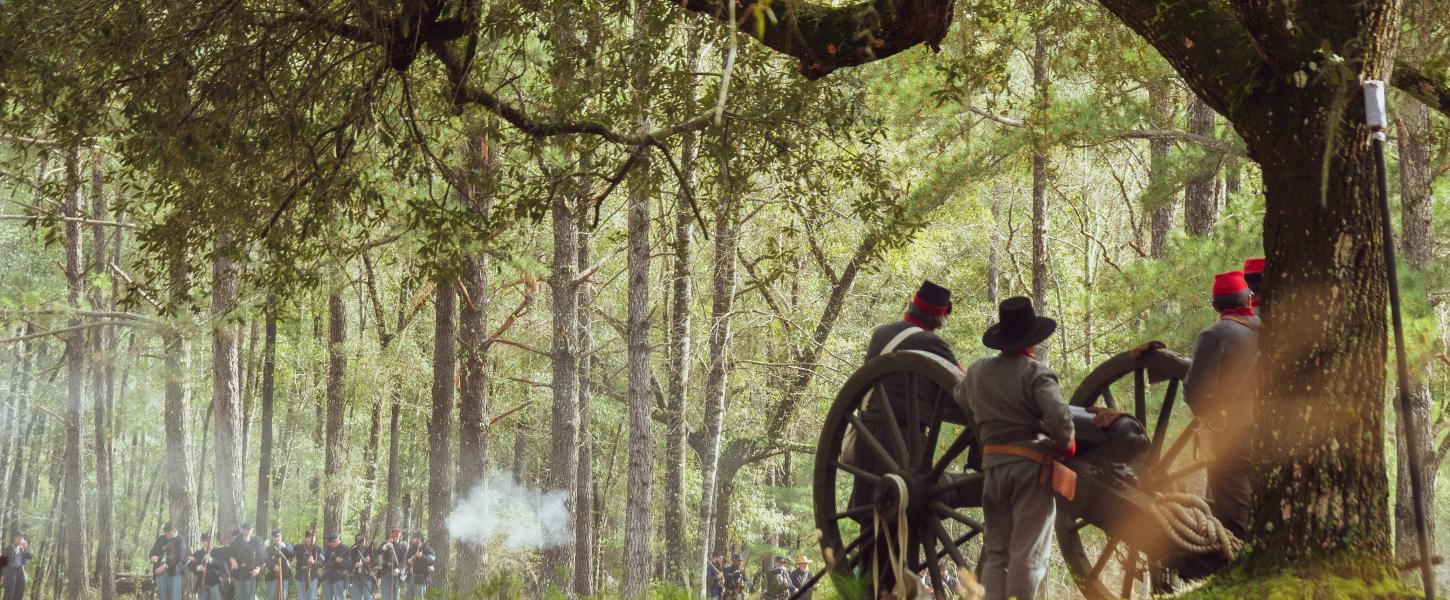 Reenactors fire cannon. 