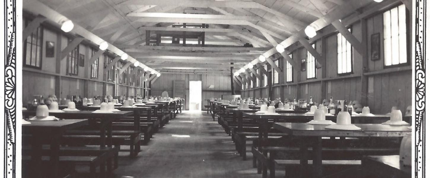 A mess hall with the tables set for the enrollees of the Civilian Conservation Corps. Some were not this fancy.