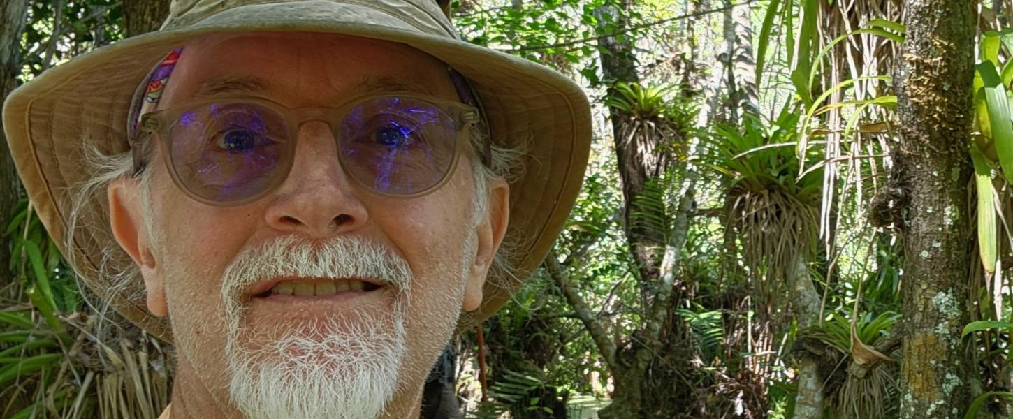 Dino Barrone smiling in front of a forest.