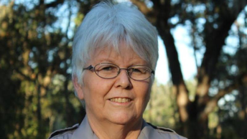 Karen Cloud, wearing her volunteer uniform and smiling at the camera.