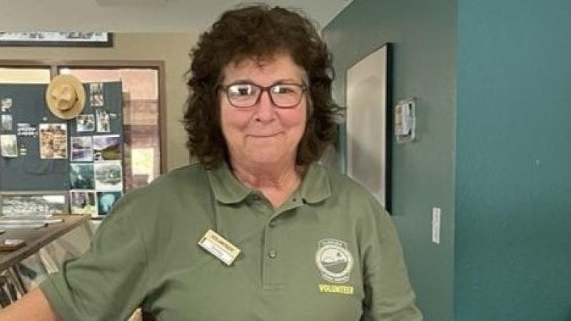 Shirley Johnson standing in a room smiling.