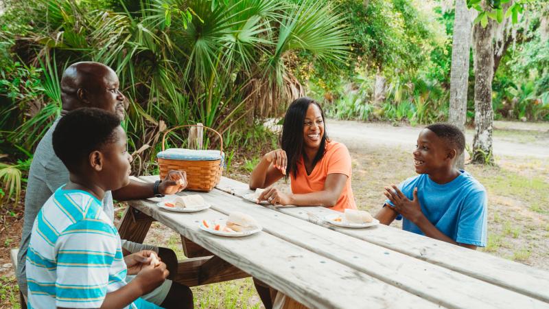 A family has a picnic at Tomoka State Park. 