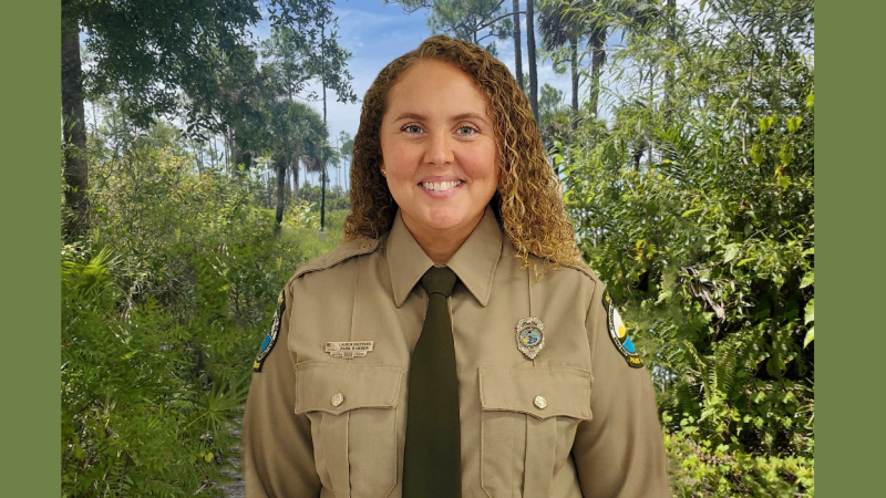 Park Ranger Lauren Sheppard in uniform with woodsy background