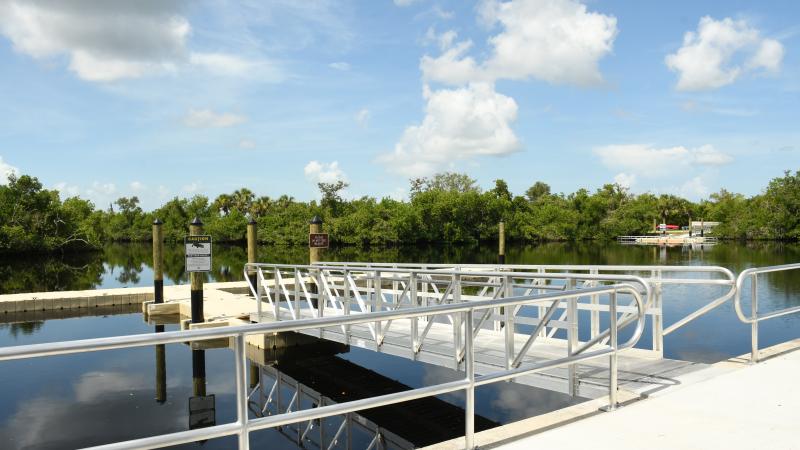 River with floating boat dock and canoe launch.