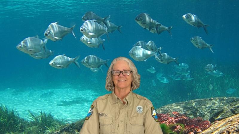 Cyndy Emrich in front of fish.