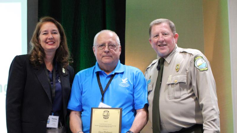 Don Philpott receives the award with Tammy Gustafson and Chuck Hatcher.