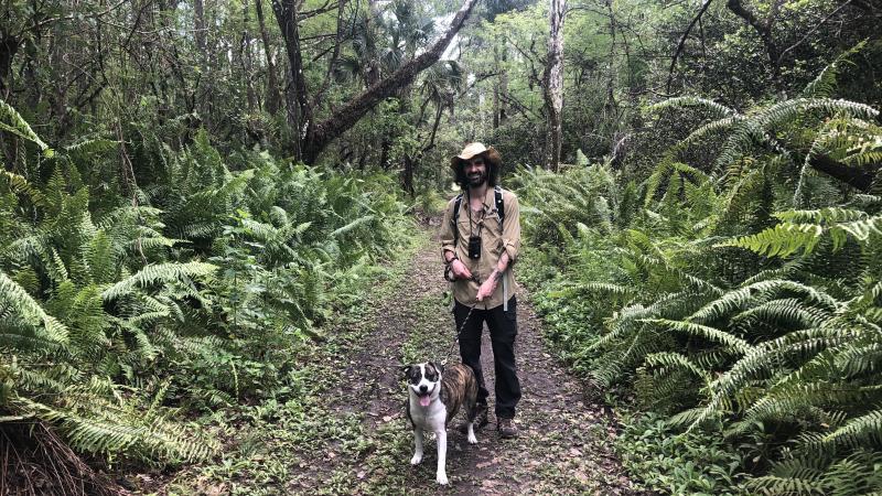 Mark Ferro and his dog, hiking on a trail at Fakahatchee Strand Preserve.