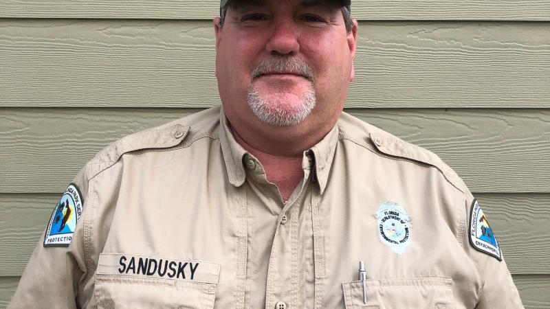 Park Services Specialist Ricky Sandusky smiles ready to greet park visitors. 