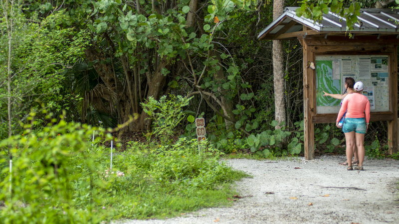 Two women looking at a trail map kiosk