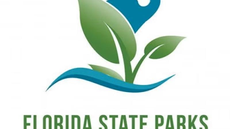 Florida State Parks Foundation Logo blue crane behind green leaves