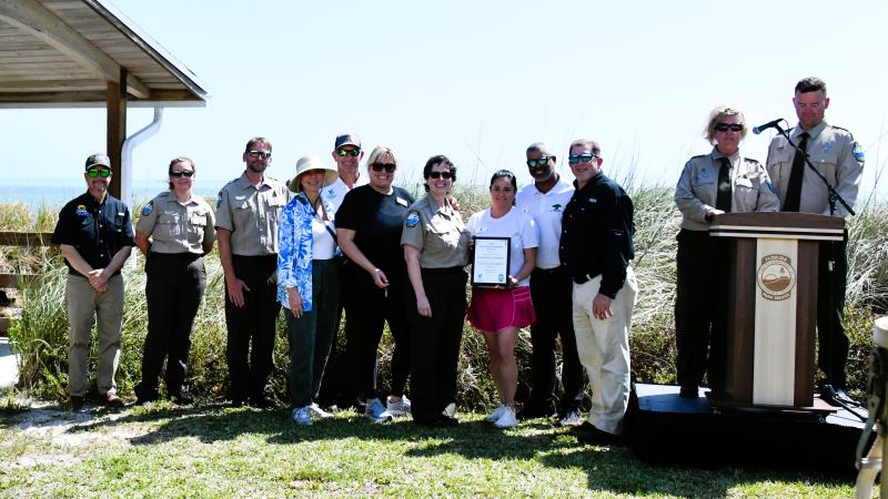group of award winning volunteers stand with proud park staff