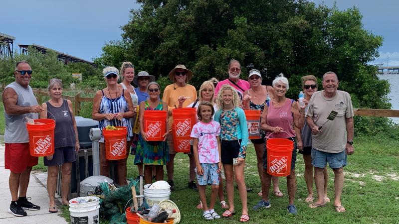A group of people pick up litter at Bahia Honda State Park.