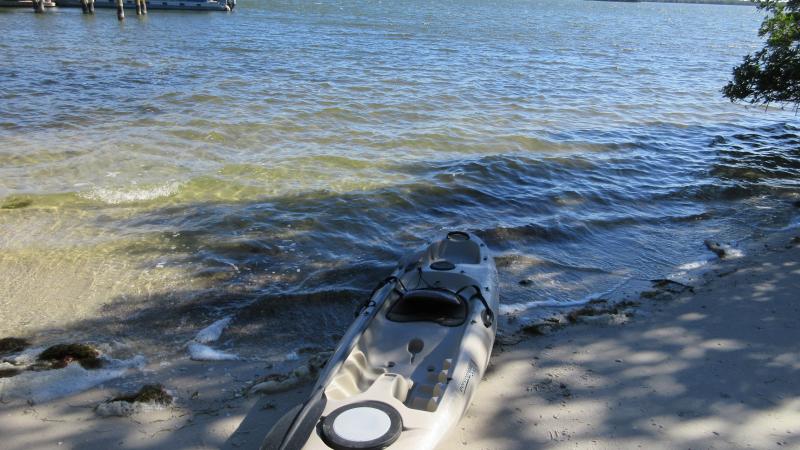 A kayak sitting by the water's edge.