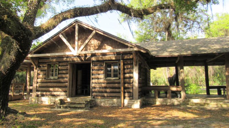 The Log Pavilion in the shade of a Live Oak