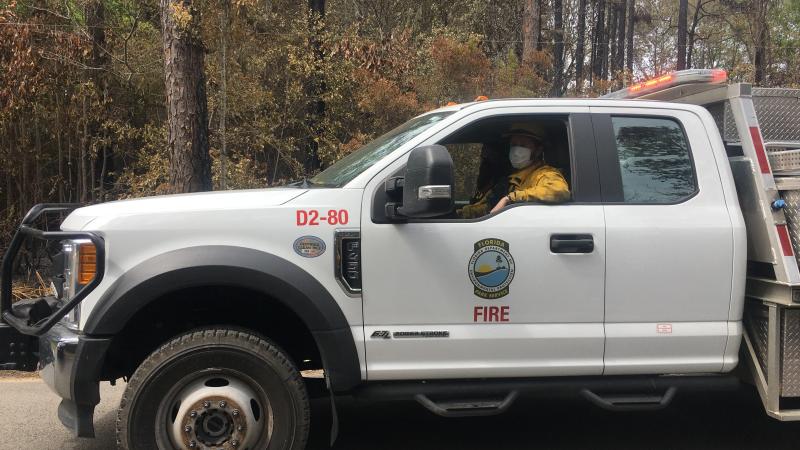 A strike team member is visible driving a fire engine. 