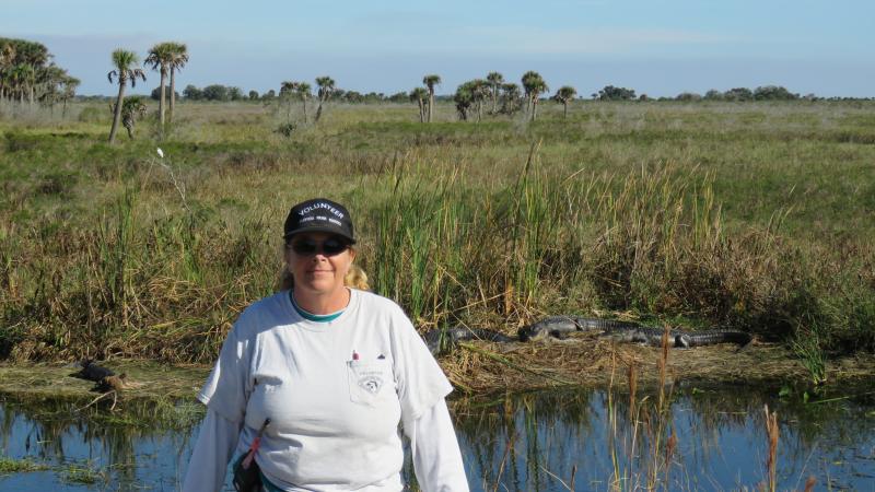 Joan, standing in front of a lake.