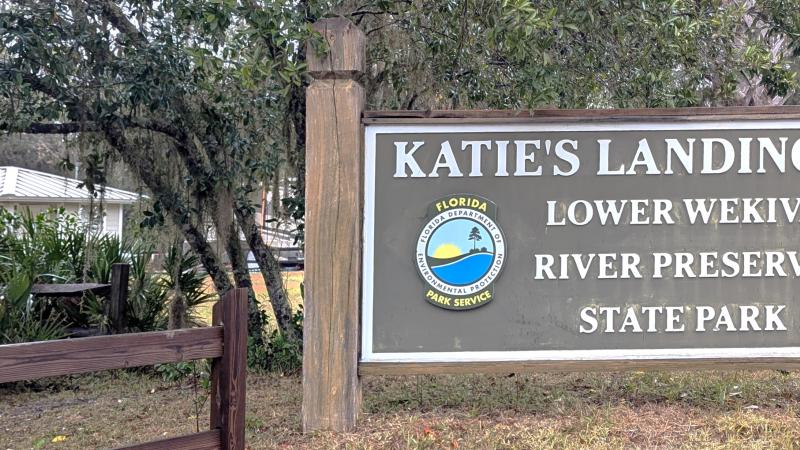 A sign that reads "Katie's Landing Lower Wekiwa River Preserve State Park". 