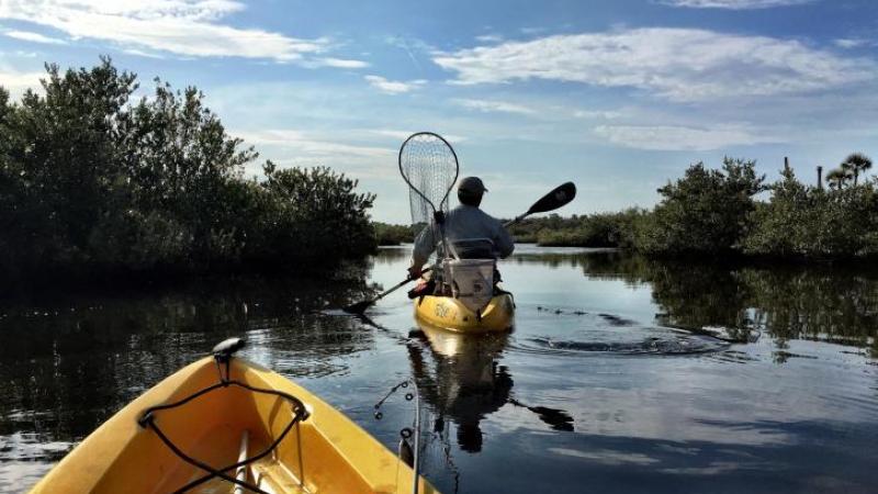 Two yellow kayaks with fishing gear at Gamble Rogers