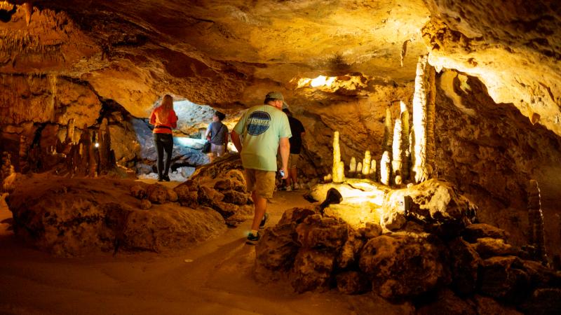 Three people on a cavern tour.