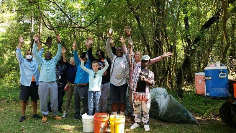 A group of students from ACE School volunteer to remove exotic plants.