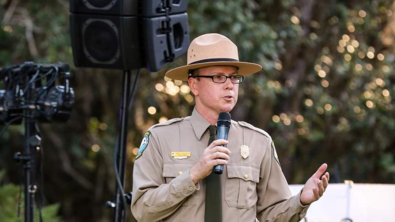 Matt Bledsoe holds a microphone.