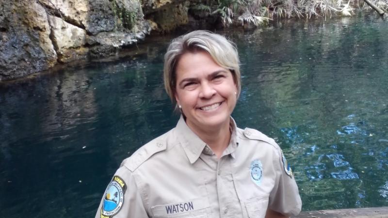 Angela Watson stands on the platform overlooking the spring.