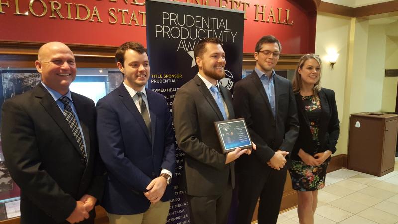 A view of the GIS team posing for a picture with their certificate.
