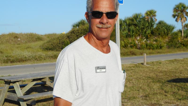 Art, standing outside, looking at the camera.