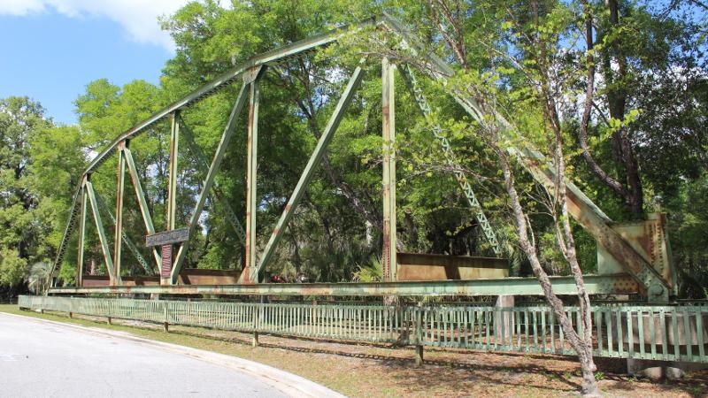 an old bridge sits on dry land