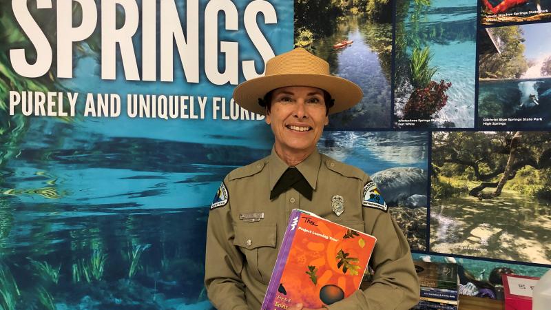 Thea Knott poses in front of a display.