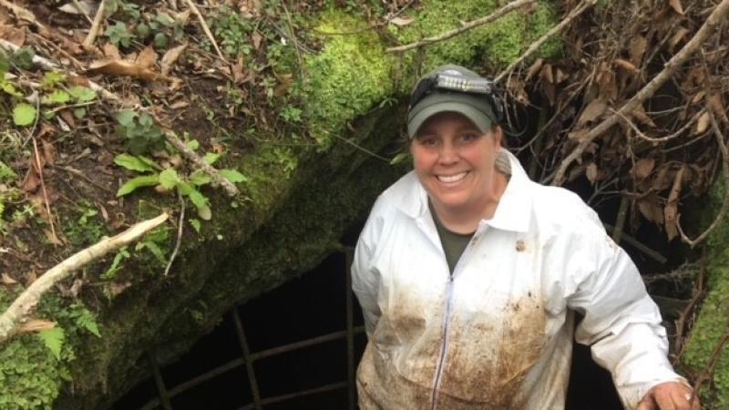Tiffany Vickery spelunking in a a cave.