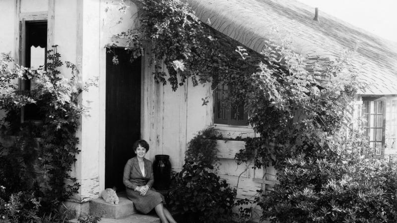 Marjory Stoneman Douglas sits on the steps of her home.