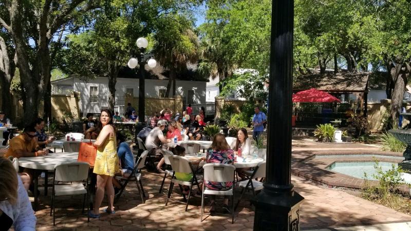 A view of people at an event in the Ybor City Museum garden.