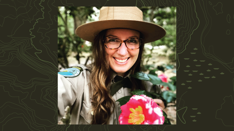 Scarlett Dunn poses with a pink flower.