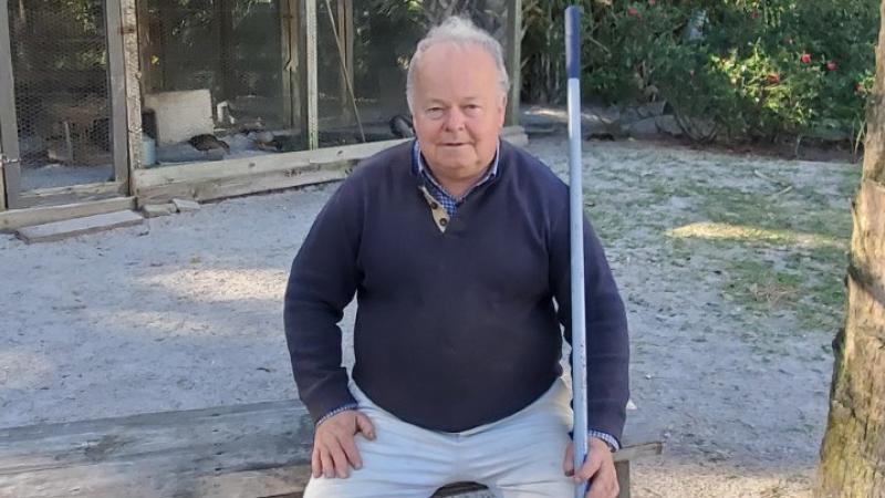 Geoffrey Gates sitting on a swing.