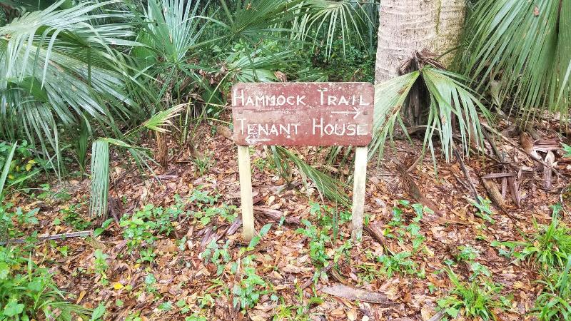 a small wooden brown sign points to the Hammock Trail and Tenant House