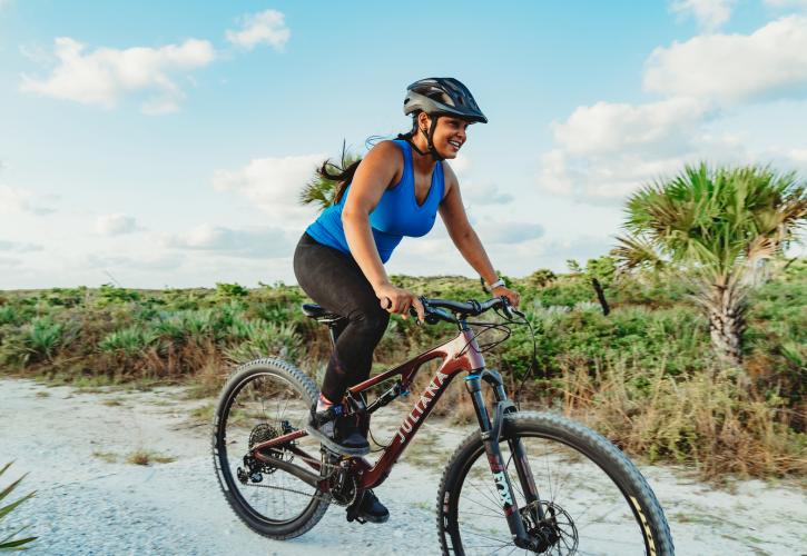 A person rides a bike at the park.