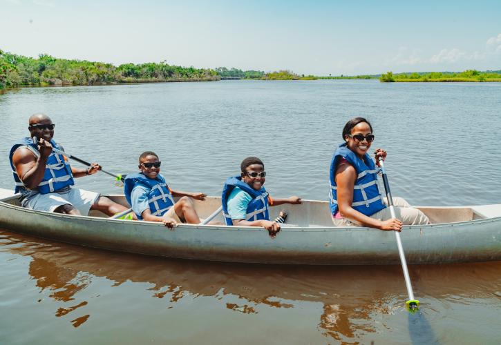 A family of four enjoys canoeing at Tomoka State Park.