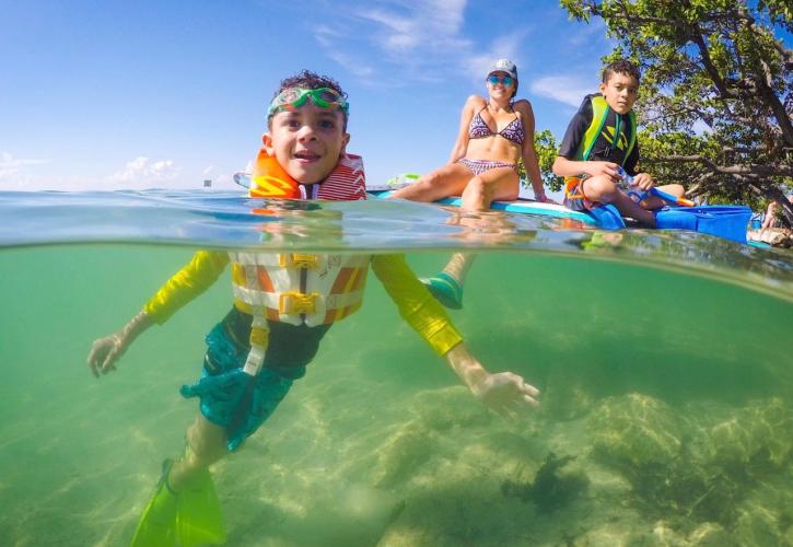 A family swimming in the water.