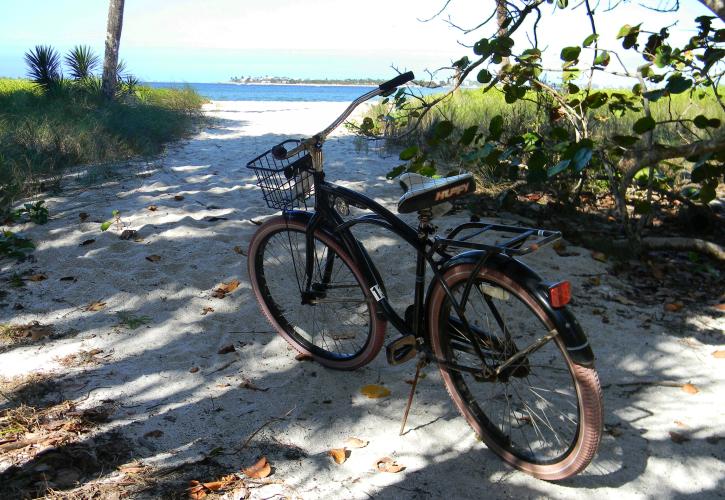 A bike in the middle of a sandy bike trail.