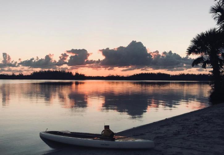 A view of a kayak by the water's shore.