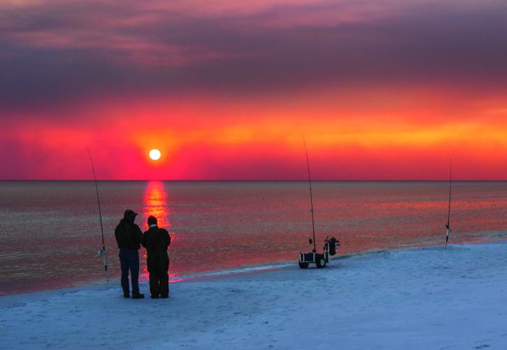 Couple fishing at sunset