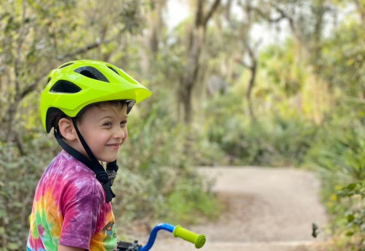 A child rides a bike on the trails.