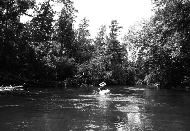 Black and white image of kayaker in the distance.