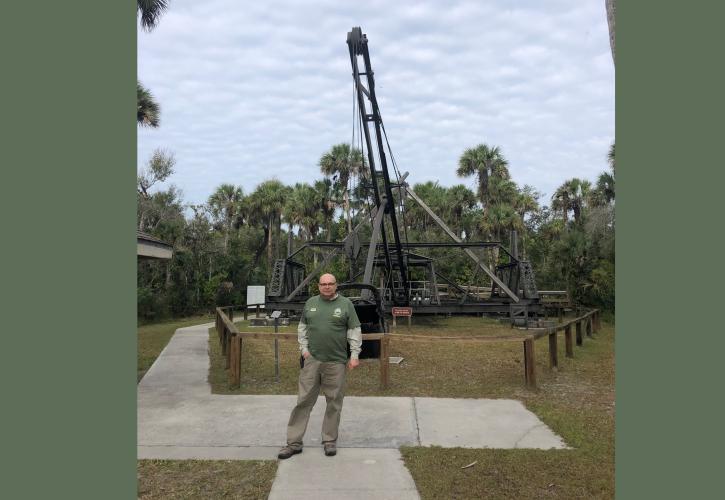 Man standing at a the Bay City Walking Dredge