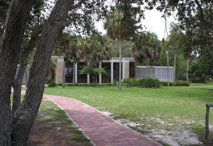 Brick path under oak tree leads to the front of the Cedar Key Museum