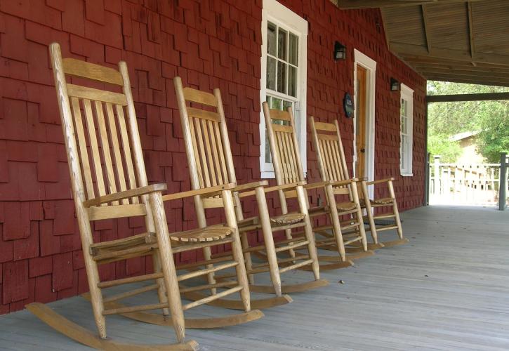 Four rocking chairs on the front of the St Clair Whitman house