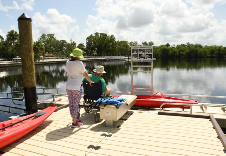 Man and woman canoe launch at river