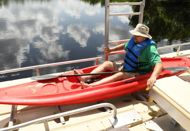 Man in a kayak at canoe launch